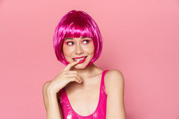 Image of joyful beautiful woman in wig smiling and looking aside