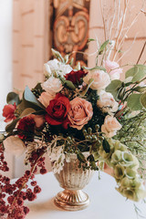 Bouquet of roses in a bronze antique vase