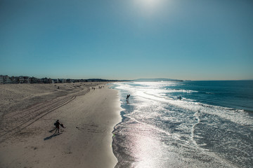 sea and sky.  surfers ride the waves and relax in breaks. Beach in Los Angeles. California. Ocean.