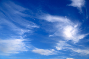 Naklejka na ściany i meble Blue sky landscape background. Picturesque beautiful cirrus clouds create unusual patterns in the sky. Cloudy weather in spring and summer.