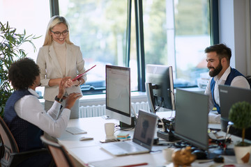 satisfied young boss blonde female listening employee, smiling. successful casual business concept