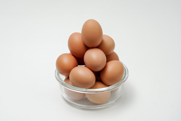 Eggs in a transparent glass bowl. A bowl of eggs