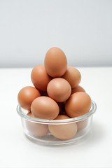 Eggs in a transparent glass bowl. A bowl of eggs