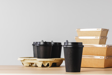 Many various take-out food containers, pizza box, coffee cups and paper bags on light grey background. Food delivery