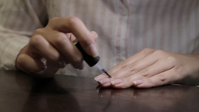 nails gel shellac painting at home using ultraviolet lamp close up. Girl doing manicure and nails with gel shellac painting

