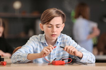 Pupil at physics lesson in classroom