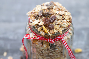 muesli in glass jar on ceramic background