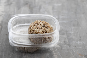 rice with morcela in plastic box on ceramic background