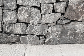 Outer wall made of rough gray stones and concrete