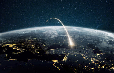 Rocket launch on a night planet earth with lights. Concept of successful satellite launch....