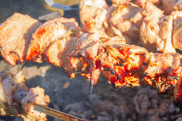 Fototapeta premium Fresh pork shish kebab is fried on skewers on the grill