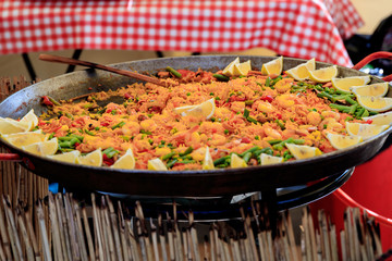 Fried rice with shrimp and vegetables on a frying pan.