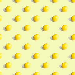 Seamless geometric pattern, whole lemon on a light yellow background. Pattern.