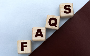 FAQS , the word is written on cubes on a gray brown background