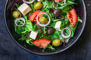 healthy salad
olives, lettuce, tomato and cheese
feta (greek salad, tasty vegetables snack) menu concept background. top view. copy space for text