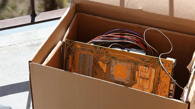 Throwing away electronic waste, man putting old obsolete pc components into a box closing it and taking it away, electro trash recycling, old computer parts trashing, eco safe electronics disposal