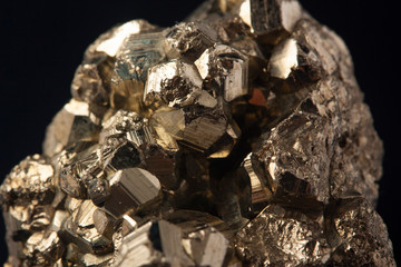 Pyrites crystals on the black background, macro, FeS2