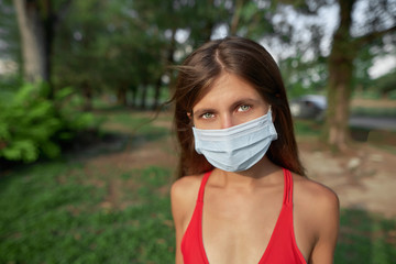 Clouse up portrait of a girl in a medical mask    