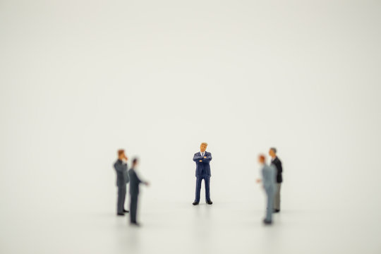 Businessman Miniature People Figure Standing Discuss With Teamwork On White Background With Copy Space.