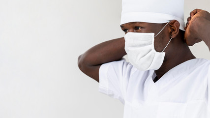 Specialist black male doctor putting the mask portrait
