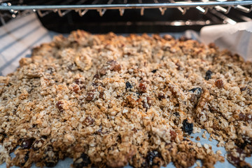granola to cook in an electric oven. concept of simple ingredients for healthy breakfast