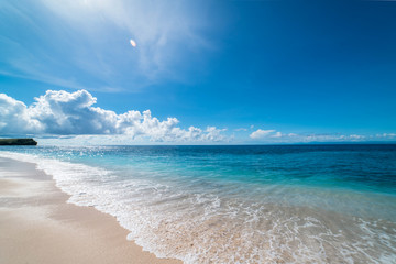 Paradise empty beach on a Tropical island. Azure sea sandy beach and blue sky.