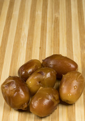 Dates close-up, on wooden background. Healthy food