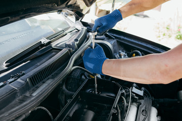An auto mechanic repairing a car engine