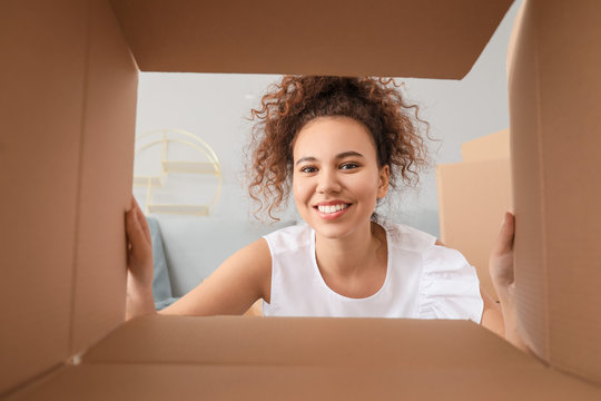 Happy woman with open box, view from inside