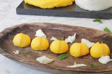 
Polenta, corn porridge, diet food. Traditional Italian food on a wooden plate with herbs and cheese.