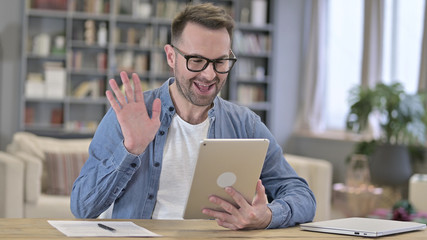 Cheerful Young Man doing Video Chat on Tablet