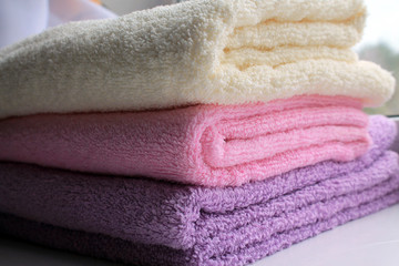 Terry towels pink, lilac, yellow folded.