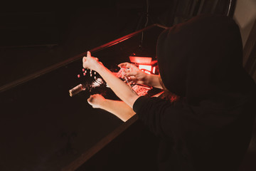 full background drug addict plans to inject heroin through a syringe into her veins on a mirrored table top view from the back. Drug abuse concept