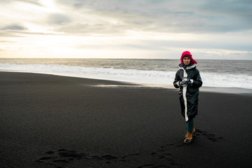 beautiful woman in black jacket traveling around Iceland 