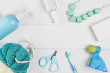 Baby accessories for hygiene and rubber toy isolated on white.