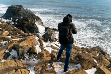 young handsome male photographer travels around iceland