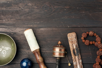 Copper singing bowl, prayer beads, prayer drum and other Tibetan religious objects for meditation...