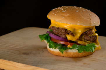 Delicious Grilled Hamburger with Cheese Served on Wooden Table