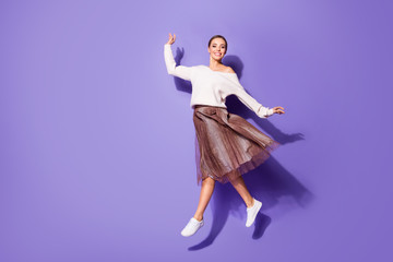 Fototapeta na wymiar Full length body size view of her she nice attractive charming fashionable cheerful girl jumping walking having fun isolated on bright vivid shine vibrant lilac violet purple color background