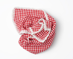 crumpled kitchen red-white towel in on a white background