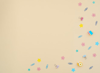 School and office supplies: clips, note paper, stickers, erasers on yellow background. Back to school, stationary, back to office concept. Not boring set for work at office. Flat lay with copy space.