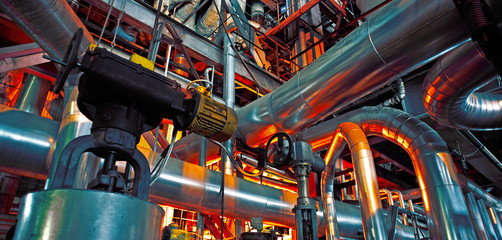 Equipment, cables and piping as found inside of a modern industrial power plant