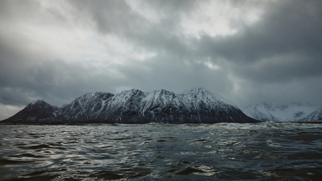Snowy mountains across the sea in the arctic