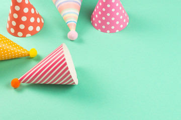 Obraz premium Colorful birthday caps on mint background.