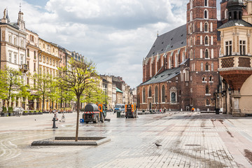 Obraz premium Almost empty Krakow Market Square in the time of pandemia (Coronavirus - Covid-19). Machines disinfect the surface