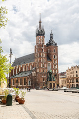 Almost empty market square in krakow during pandemic (coronavirus, covid-19) time. St Mary Church adn a sunny warm day in Krakow, Lesser Poland, Poland.