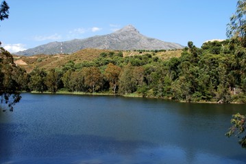 View across the lake towards the mountains at Nueva Andalucia Nature Reserve, Marbella, Andalusia, Spain.