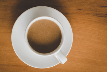 A cup of coffee with coasters for coffee isolated on wooden table, flat lay and top down horizontal view.