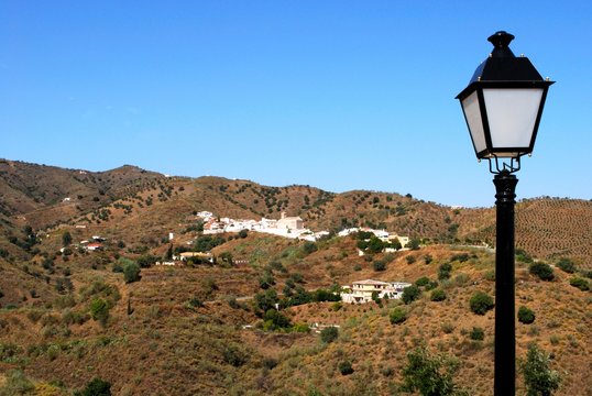 View of village with a streetlight in the foreground, Benaque, Andalusia, Spain.