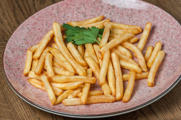 french fries with parsley in a pink plate